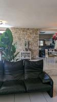 a black leather couch sitting in a living room at Villa Khaki 