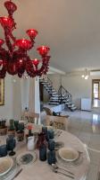 a room with a table with plates and a chandelier at Villa Khaki 