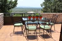 a table and chairs on a patio with a view at Villa Khaki 