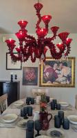 a dining room with a table with red chandelier at Villa Khaki 