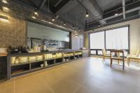 a kitchen with a table and chairs in a room at Hotel Demer Mokpo in Mokpo