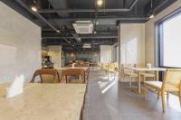 a dining room with tables and chairs and a cafeteria at Hotel Demer Mokpo in Mokpo