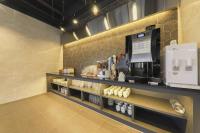 a coffee shop with a coffee machine on a shelf at Hotel Demer Mokpo in Mokpo