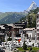 a town with a mountain in the background with a resort at Grand Hotel Zermatterhof in Zermatt