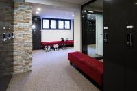 a hallway with a red couch and a mirror at Grand Hotel Zermatterhof in Zermatt