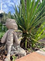 a statue of a person standing next to a plant at Mas La Farelle Chambre d&#39;hote,Fitness &amp; Salle de jeux Gratuite &amp; SPA en supplément in Nîmes