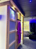 a door to a room with a purple robe on it at Mas La Farelle Chambre d&#39;hote,Fitness &amp; Salle de jeux Gratuite &amp; SPA en supplément in Nîmes