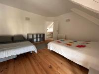 a bedroom with two twin beds and a staircase at Le ker Maclow in Saint Malo
