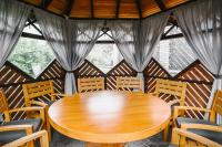 a wooden table and chairs in a room at Zagorod Hotel in Girka Polonka