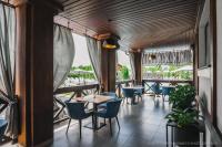 a restaurant with tables and chairs and a balcony at Zagorod Hotel in Girka Polonka