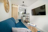 a living room with a blue couch and a table at Gallia Blue By SCLS Locations in Cannes