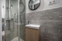 a bathroom with a sink and a shower with a mirror at Gallia Blue By SCLS Locations in Cannes