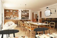 a restaurant with tables and chairs and a kitchen at Residence Inn by Marriott Paris Didot Montparnasse in Paris