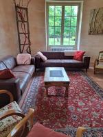 a living room with a couch and a coffee table at Château de la Comtesse in Saint-Martin-Petit
