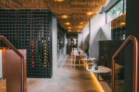 a restaurant with a row of tables with wine bottles at Hotel Lisboa in Lisbon