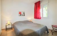 a bedroom with a bed and a window with a red curtain at Amazing Home In Grospierres With Outdoor Swimming Pool, Wifi And 2 Bedrooms in Grospierres