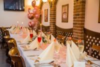 a long table with white table cloths and wine glasses at Hotel Bílý Beránek Kralovice in Kralowitz