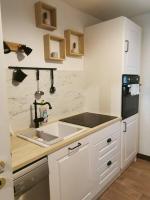 a kitchen with a sink and a counter top at appartement cosy à 10 min du centre de Strasbourg in Strasbourg