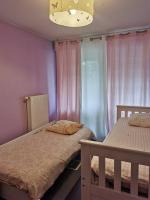 a bedroom with two bunk beds and a window at appartement cosy à 10 min du centre de Strasbourg in Strasbourg