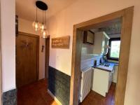 a kitchen with a sink and a stove top oven at Le Repère des Quatre Dubois in Le Tholy