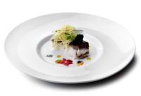 Un plato blanco con un trozo de comida encima. en Il Falconiere Relais & Spa, en Cortona