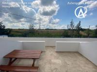 a wooden bench sitting on top of a white balcony at Auberge des Plaines - Appartements avec terrasse in Arles