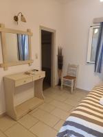 a bedroom with a bed and a desk and a mirror at Theofanis Studios in Agia Anna Naxos
