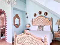 a bedroom with a large bed and a mirror at England Castle B&amp;B in Wujie