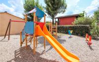 a playground with a slide in a yard at Amazing Home In Grospierres With Outdoor Swimming Pool, Wifi And 2 Bedrooms in Grospierres