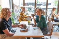 two women sitting at a table in a restaurant at Anders Apartments in Jena