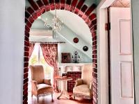 an archway in a living room with two chairs and a table at England Castle B&amp;B in Wujie