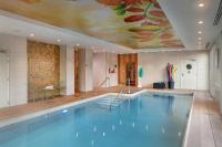a large swimming pool with a painting on the ceiling at DOMITYS LES CERNEAUX in Hazebrouck