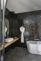 a bathroom with two sinks and a bath tub at MiHotel Sala in Lyon