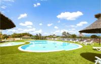 a large swimming pool with chairs and umbrellas at Amazing Home In Grospierres With Outdoor Swimming Pool, Wifi And 2 Bedrooms in Grospierres