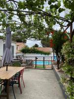 a patio with a table and an umbrella and a pool at Maison en Provence in Salon-de-Provence