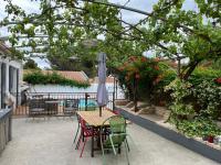 a table and chairs with an umbrella on a patio at Maison en Provence in Salon-de-Provence