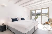 A bed or beds in a room at NEW - Villa Aperanto - MG Villas Mykonos