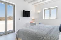 A bed or beds in a room at NEW - Villa Aperanto - MG Villas Mykonos