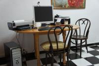 a desk with a computer and a printer on it at Pensión San Benito Abad in Seville