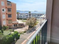 a balcony of a building with a view of a marina at Appartement Six-Fours-les-Plages, 2 pièces, 5 personnes - FR-1-316-118 in Six-Fours-les-Plages