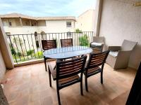 a patio with a table and chairs on a balcony at Appartement Six-Fours-les-Plages, 2 pièces, 5 personnes - FR-1-316-118 in Six-Fours-les-Plages