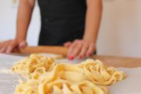 a person is making pasta on a cutting board at Villa LeMarche b&b in Rustico