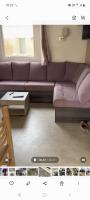 a living room with a purple couch and a table at Mobil-home Les Dunes de Contis in Saint-Julien-en-Born