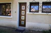 a house with a brown door and windows at REZ DE JARDIN AU COEUR DES PYRENEES in Agos-Vidalos
