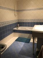 a blue and white bathroom with a tub and a sink at Pour la période des Jeux Olympiques 2024 seulement Duplex de 4 chambres à 100 mètres de Paris for Olympics 2024 only 4 bedroom duplex 100 meters from Paris in Montrouge