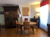 a dining room with a wooden table and chairs at Pour la période des Jeux Olympiques 2024 seulement Duplex de 4 chambres à 100 mètres de Paris for Olympics 2024 only 4 bedroom duplex 100 meters from Paris in Montrouge