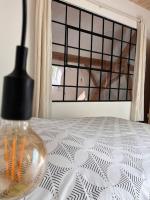 a glass vase sitting on a bed with a window at Le grenier a foin in Breitenbach-Haut-Rhin
