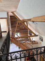 a staircase in a house with wooden ceilings at Le grenier a foin in Breitenbach-Haut-Rhin