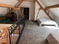 a attic room with a bed and a staircase at Le grenier a foin in Breitenbach-Haut-Rhin