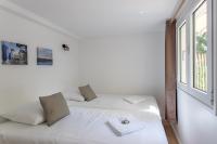 a white bed in a room with a window at Villa des Sables in Lège-Cap-Ferret